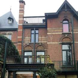 Discreet fire escape ladder for historical facades Closed black fire escape retractable ladder on historical brick facade.